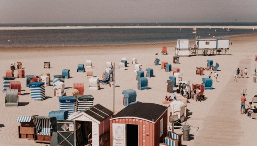 Colorful beach cabins on the sandy shores of Borkum, Germany.