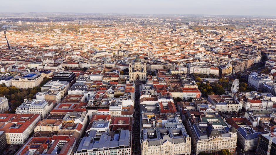 Discover the sprawling cityscape of Budapest, Hungary, from an aerial perspective on a clear day.