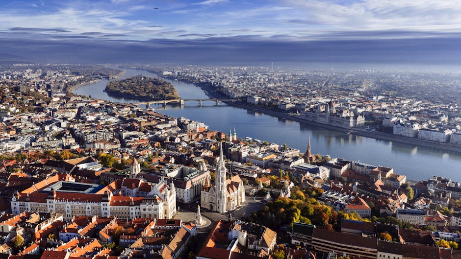 Stunning aerial view of Budapest featuring the Danube River and iconic landmarks on a clear day.