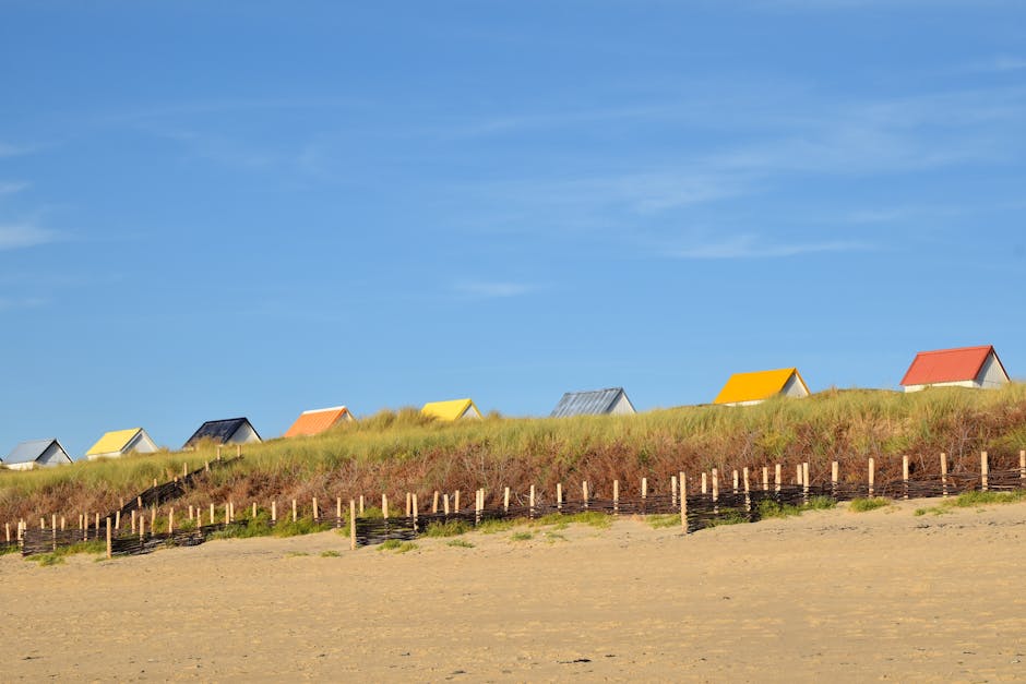 Scenic beach with vibrant rooftops and clear blue sky, perfect for travel and relaxation.