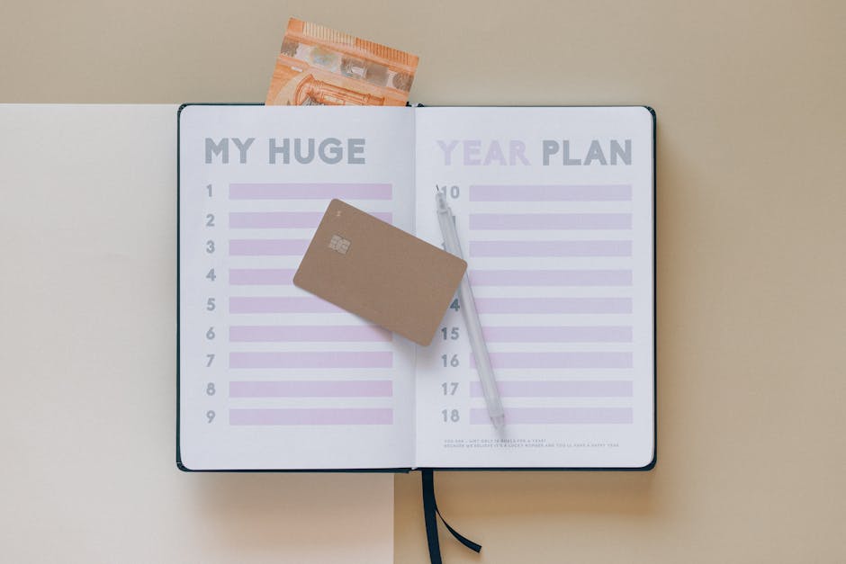 Open planner with a credit card and pen, perfect for financial planning visuals.